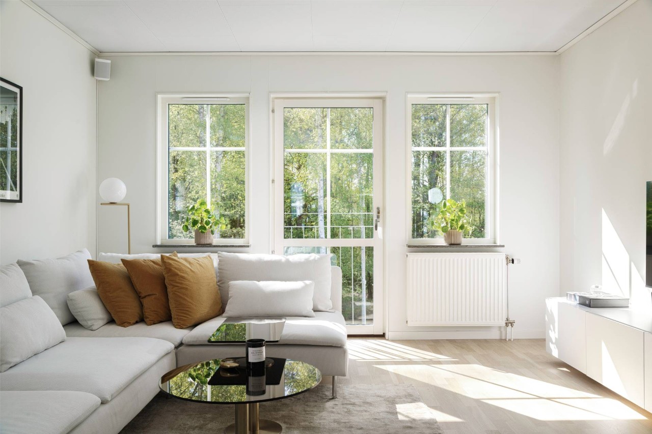 A living room with a beautiful view of nature through the windows at Royal Furniture & Design near Key West, FL