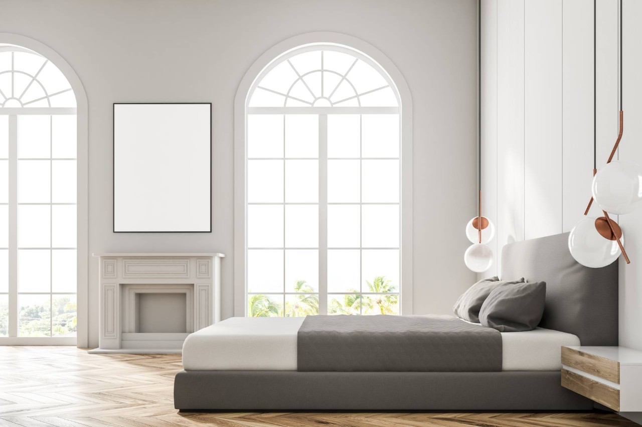 A bedroom with tall windows and half-circle windows at Royal Furniture and Design near Key West, FL.